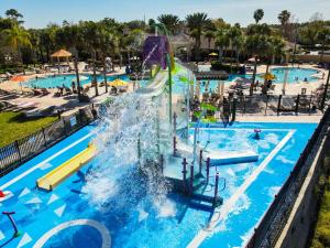 a pool with a water park with a water slide at 3 Bedroom Condo with Water Park & Fantastic Pool only Minutes To Walt Disney World's Front Gate!!! in Orlando