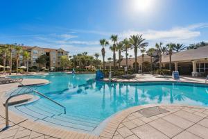 a large swimming pool at a resort with palm trees at Water Park & Fantastic Pool only Minutes To Walt Disney World's Front Gate!!! in Orlando