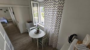 a dining room with a table and a window at Acapella soba in Crikvenica +26 photos