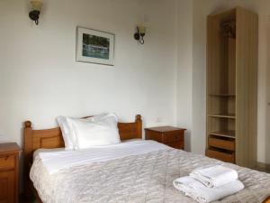 a bedroom with a bed with two towels on it at Hikers Villa Trail 5 & 6 in Skiathos Town +31 photos