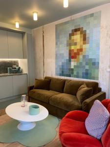 a living room with a couch and a table at Le studio Grande Maison Perrier in Montbrison
