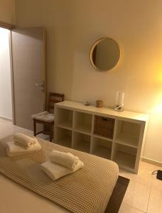 a room with a table with two towels on a bed at Sofia's Apartment in Nea Moudania