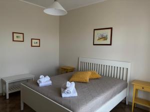 a bedroom with a bed with towels on it at Terrarossa in Crispiano +13 photos