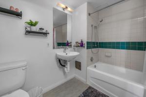 a bathroom with a sink and a toilet and a bath tub at Promenade Studio in Los Angeles +11 photos