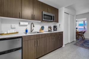 a kitchen with a sink and a microwave at Promenade Studio in Los Angeles