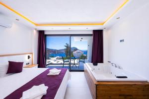 a bedroom with a bed and a tub and a sink at Villa Lovelet 2 in Kas +53 photos