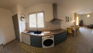a kitchen with a sink and a stove top oven at Nid Douillet Climatisée ''MEETT - Aéroscopia - TRAMWAY'' in Aussonne +2 photos