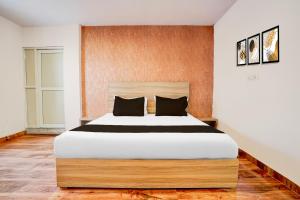 a bedroom with a large bed in a room at Hotel O P2 in Bhopal