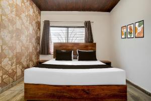 a bedroom with a large bed in a room at Hotel O P2 in Bhopal