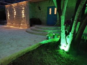 a house with a tree and a blue door at Iris 2 BR Apartment In Batroun in Batroûn