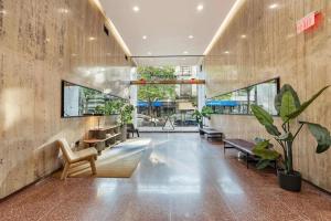a lobby with benches and plants in a building at Optimum - Downtown Oasis in Birmingham