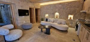 a living room with a couch and a table and chairs at Iris 2 BR Apartment In Batroun in Batroûn