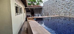 a house with a swimming pool next to a building at casa em salinopolis in Salinópolis
