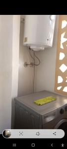 a kitchen with a stove and a white microwave at Apartamento en Rabat al lado del Mar in Oulad Akkou +9 photos