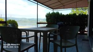 a table and chairs on a patio with a view of the water at House for us Vinci 1 in Vinci