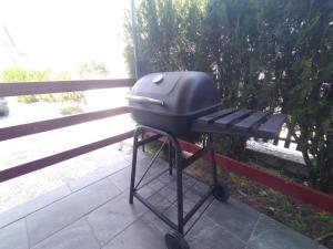 a grill on a stand on a porch at House for us Vinci 1 in Vinci