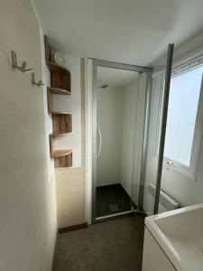 a bathroom with a shower with a glass door at La Parenthèse du Phare in Le Portel