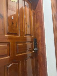 a wooden door in a room with at ملاذ للشقق المفروشة 2 in Tabuk