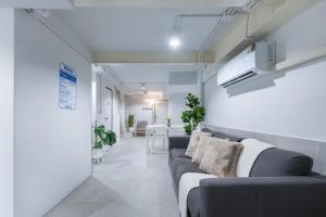 a living room with a couch and a table at Petchaburi22 Apartments next to Platinum mall in Bangkok +4 photos