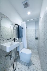 a bathroom with a sink and a toilet and a mirror at Petchaburi22 Apartments next to Platinum mall in Bangkok
