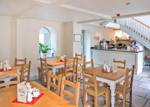 a restaurant with wooden tables and chairs and a kitchen at York House Holiday Park in Thirsk +23 photos
