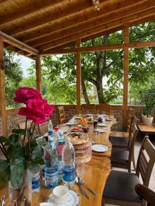 a long wooden table with food and water bottles at Ala-Archa Mountain House in Vorontsovskoye