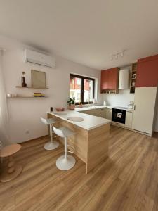 a kitchen with a island in the middle of a room at Apartamenty Pastelove Nałęczów in Nałęczów