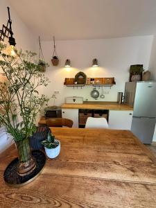 a kitchen and dining room with a wooden table at EifelZeit 1 in Kall