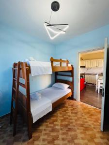 a bedroom with two bunk beds in a room at Beachfront Bliss Central 2BR Apartment in Durrës