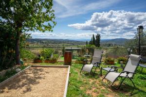瓦伦西亚Beautiful Villa with huge private pool and vineyard view的山景庭院配有椅子