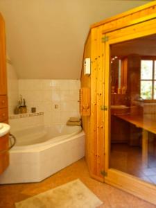 a large bathroom with a tub and a sink at Villa Sara - Wörtherseeblick, Skifahren, Sauna in Sankt Bartlmä