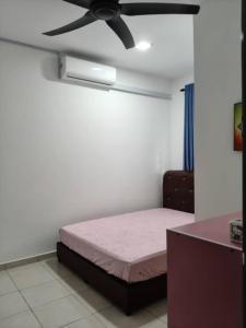 a bedroom with a bed and a ceiling fan at Little LN Homestay KLIA in Banting