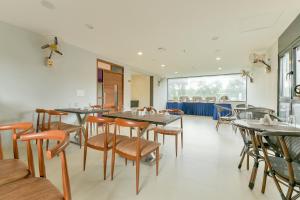 a dining room with tables and chairs at Townhouse Edassery Blue Bells in Cochin +37 photos