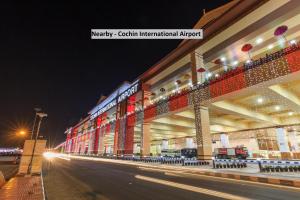 a large building with lights on the side of a street at Townhouse Edassery Blue Bells in Cochin