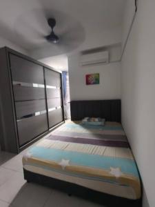a bedroom with a bed with stars on it at Little LN Homestay KLIA in Banting