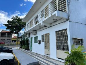 a white building with a door on the side of it at Betesda 2197F in São Luís