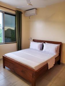 Ένα ή περισσότερα κρεβάτια σε δωμάτιο στο Casa Nampala Diani