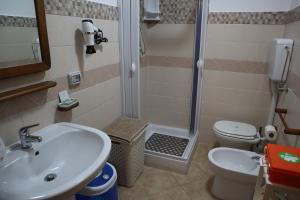 a bathroom with a sink and a shower and a toilet at Casa Vacanze Sicilia Tirrena in Finale +3 photos
