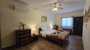 a bedroom with a bed and a ceiling fan at Villa OceanKokia in Albufeira +53 photos