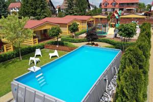 an overhead view of a swimming pool with a playground at Stacja Lato domki dla rodzin z dziećmi in Mikołajki