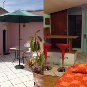 パレルモにあるAppartamento Vacanze A Palermoのテーブルと傘付きの部屋、キッチンが備わる客室です。