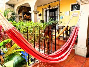 a hammock hanging from a balcony in a house at Casa Quetzalli, La Recolección in Antigua Guatemala