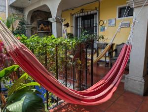 a hammock hanging from a fence in a house at Casa Quetzalli, La Recolección in Antigua Guatemala