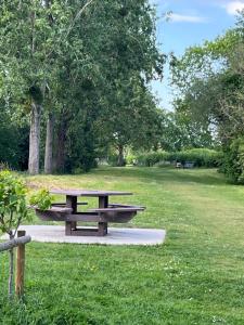 a picnic table in a park with trees and grass at Fabuleux studio à 2 pas du Canal de l'Orne in Hérouville-Saint-Clair +2 photos