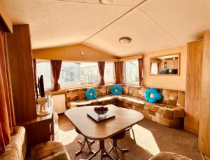 a living room with a couch and a table at Ocean Pearl Home in Heysham