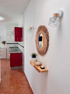 a bathroom with a mirror on a white wall at Roque`s House A in Telde +49 photos