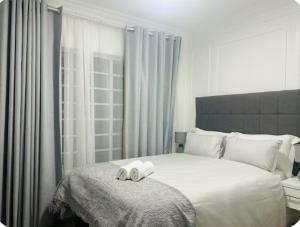 a bedroom with a bed with two towels on it at 4beds,3 bedrooms,Braai,Full kitchen in Tzaneen