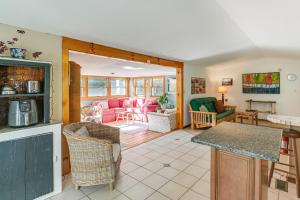 a kitchen and living room with pink furniture at 13 Mi to Acadia Artistic Retreat in Nature in Trenton