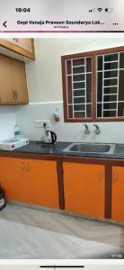 a kitchen with a sink and a counter top at Comfy home, 3 bedroom, 2 attached bathroom, large hall, kitchen, first floor, lift, covered car park in Chennai