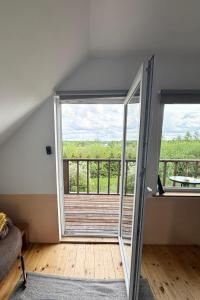 a room with a door leading to a balcony at Getaway from the city in Paspėriai +4 photos